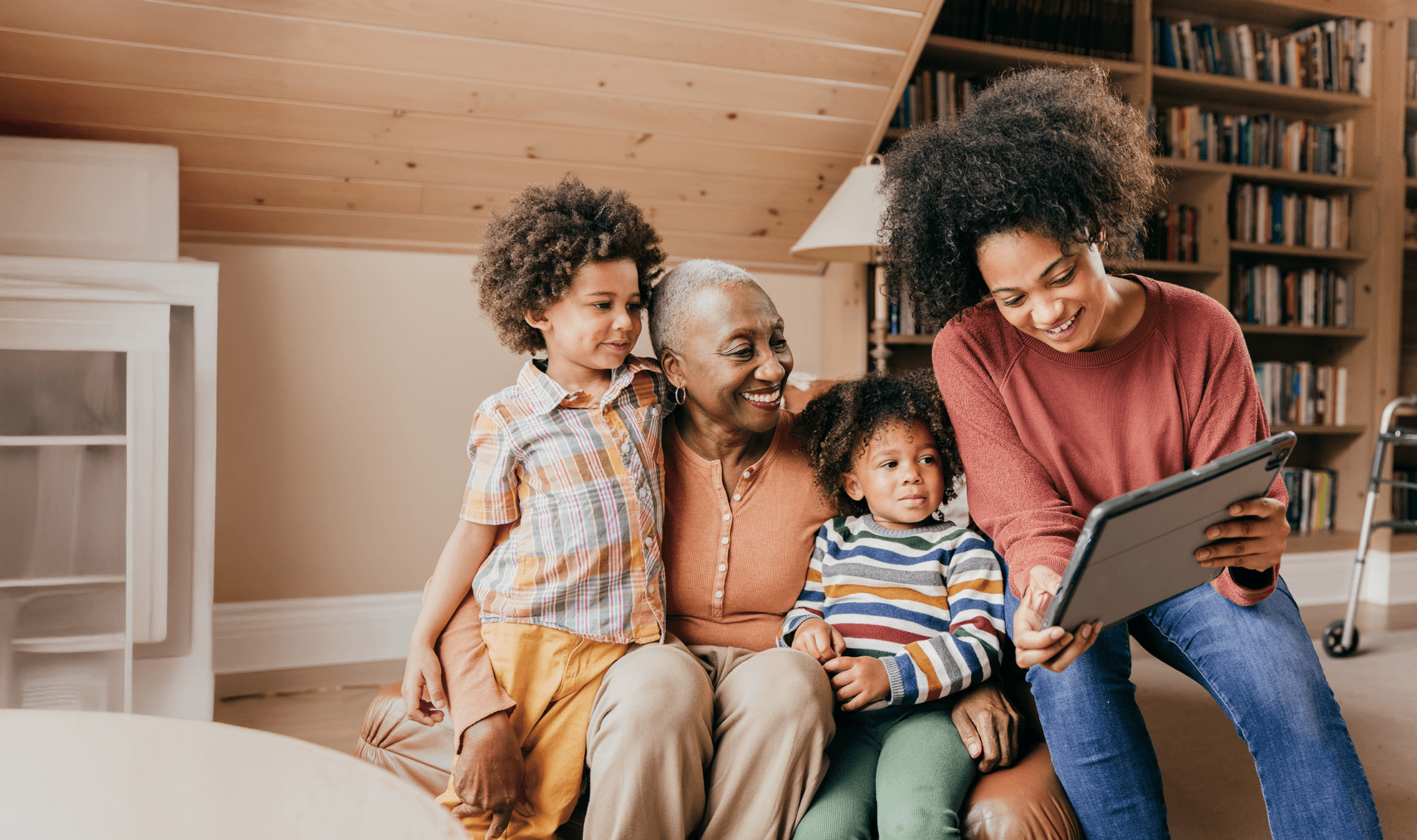 Two women and two children looking at a book together