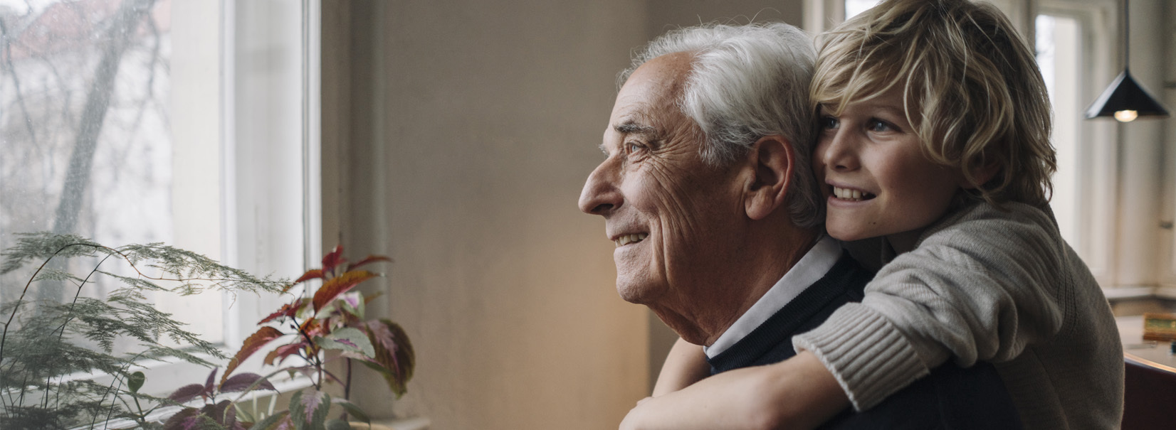 grandchild on grandfathers back looking out the window
