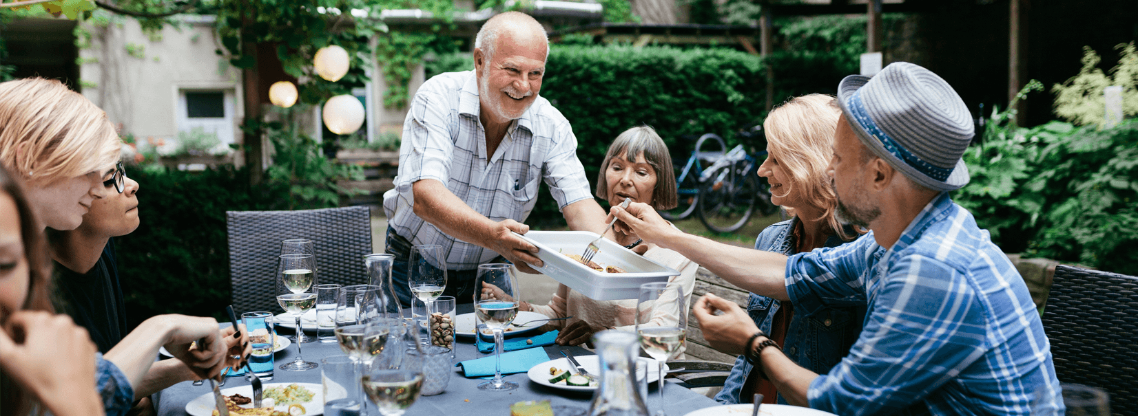 family having dinner outside in the garden