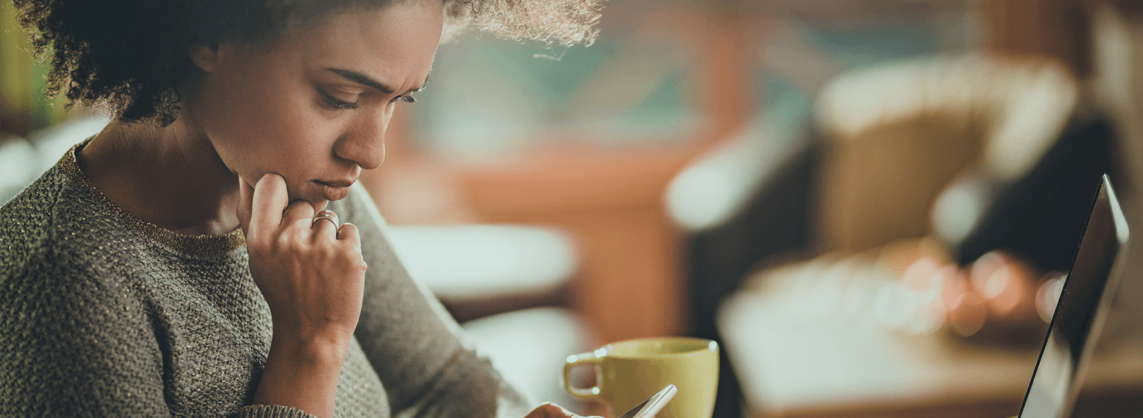 women looking at her phone concerned in a cafe